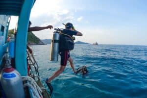 A scuba diver on their open water course, learning the giant stride entry. On their way to a scuba certification Koh Tao