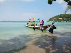 Scuba divers getting on to a Koh Tao taxi boat